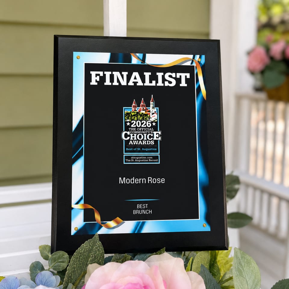 Framed award announces Modern Rose as a 2026 finalist for Best Brunch, displayed among pink and white flowers.